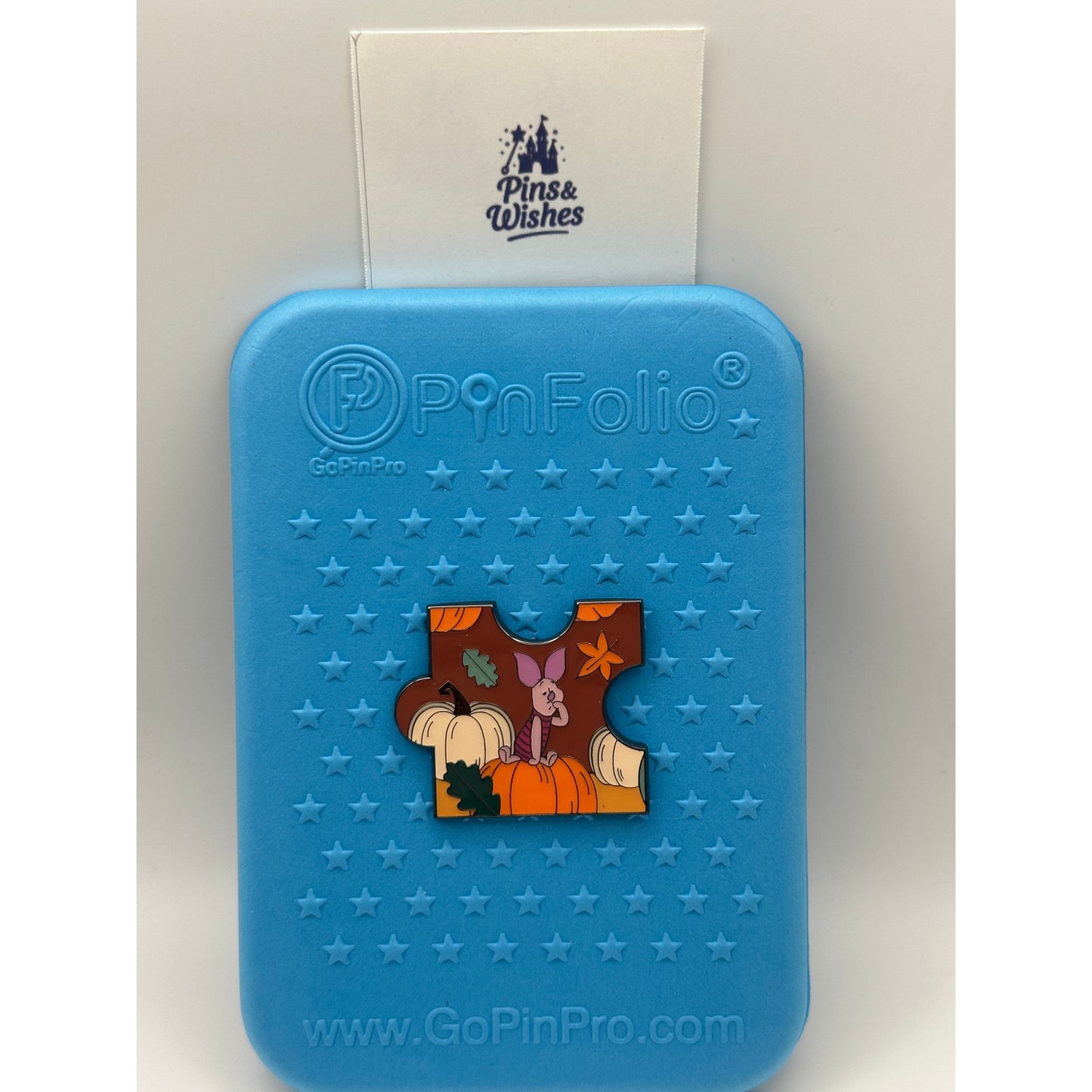 Loungefly Disney Winnie the Pooh Autumn Puzzle Blind Box Enamel Pin - Piglet on a blue background pin board with Pins and Wishes Logo