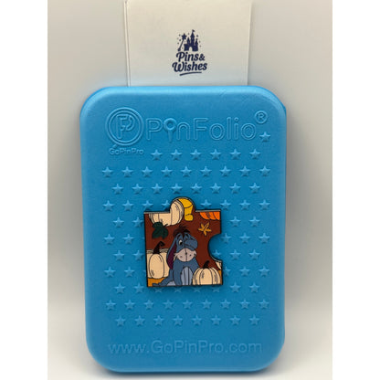 Loungefly Disney Winnie the Pooh Autumn Puzzle Blind Box Enamel Pin - Eeyore on a blue Background pin board with the Pins and Wishes Logo